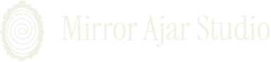 Mirror Ajar Studio logo, depicting a swirling portal through an ornate mirror
